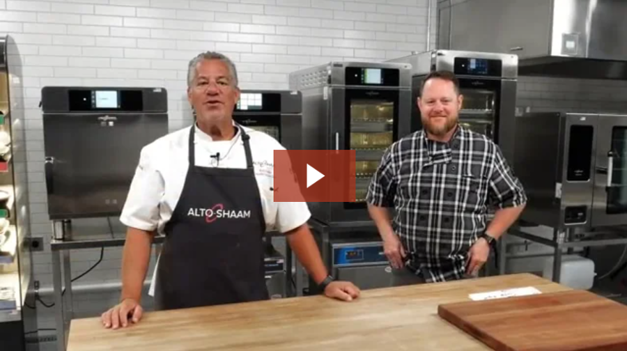 Two chefs standing behind a table